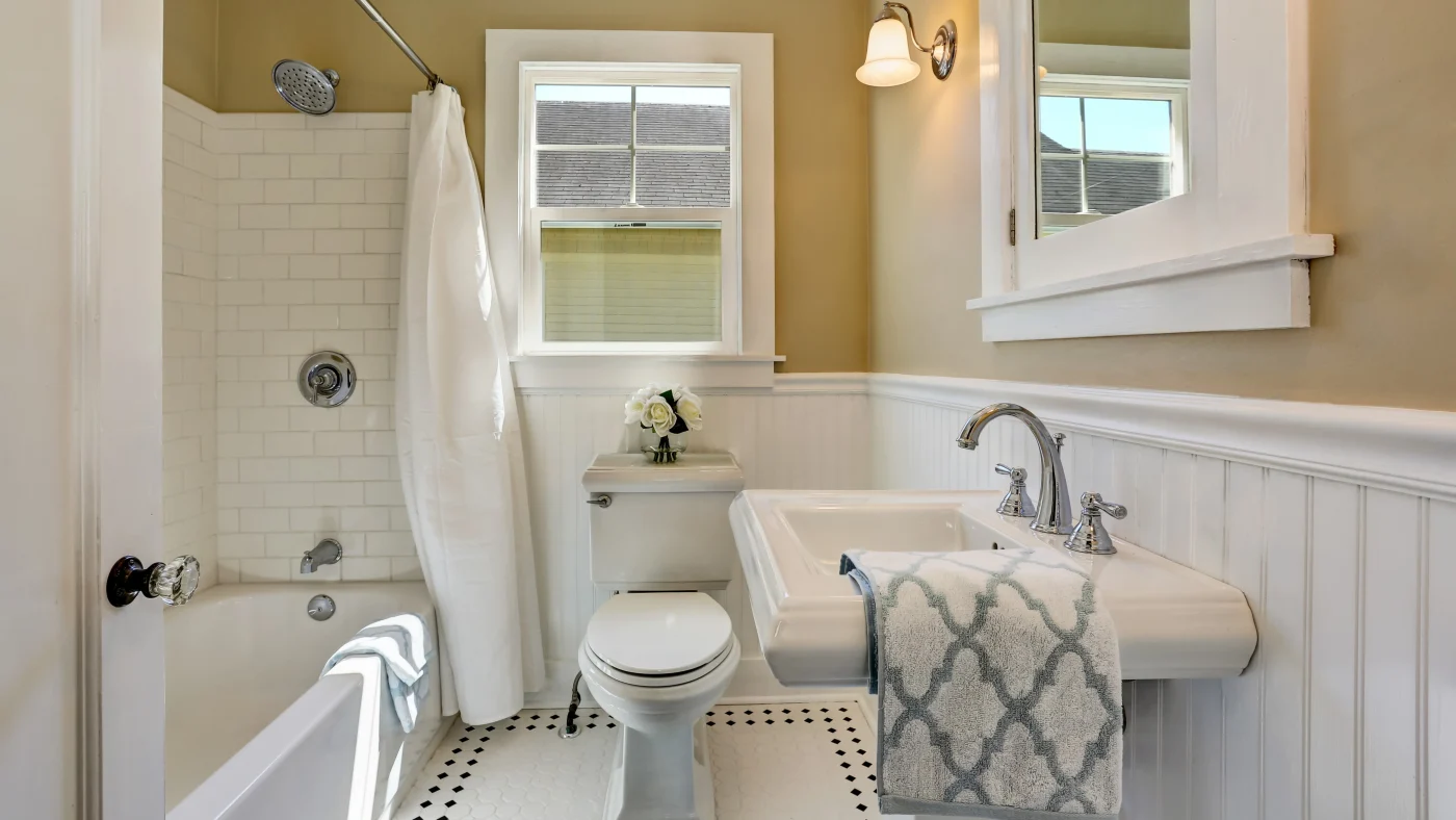 Small cozy bathroom remodel with small window and tiled shower