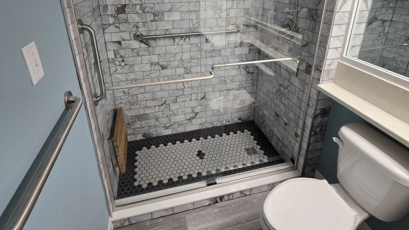 Best Full Bathroom Remodels In Georgetown, DE | Mast Contracting A beautiful new shower remodel with a sliding glass door, small tile flooring, and subway tile walls.