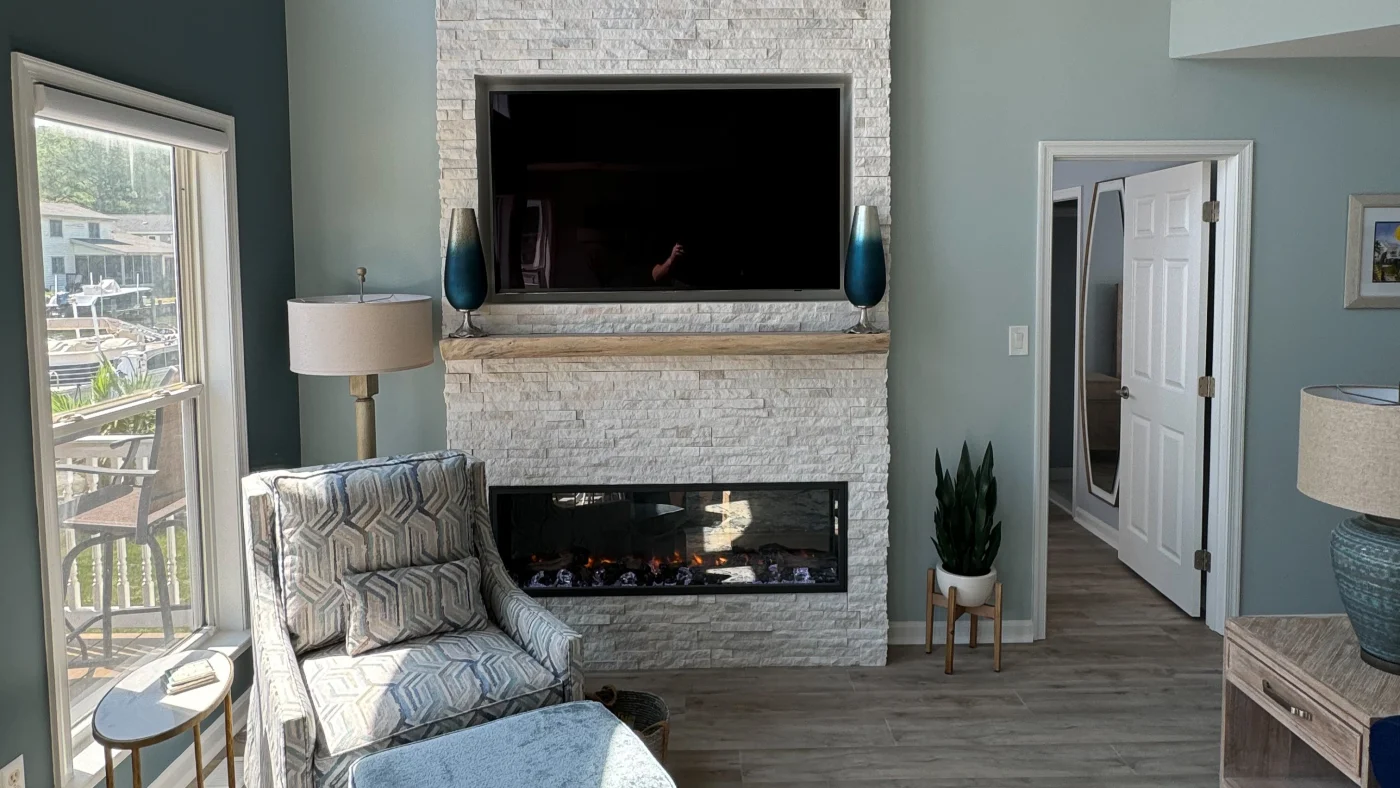 Best Interior Remodeling Company In Georgetown, DE | Mast Contracting Beautiful newly installed fireplace with white bricks and a TV mounted on top of it.