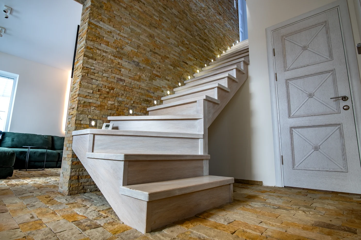 Beautiful stairs that have been redone leading into the basement of a house.
