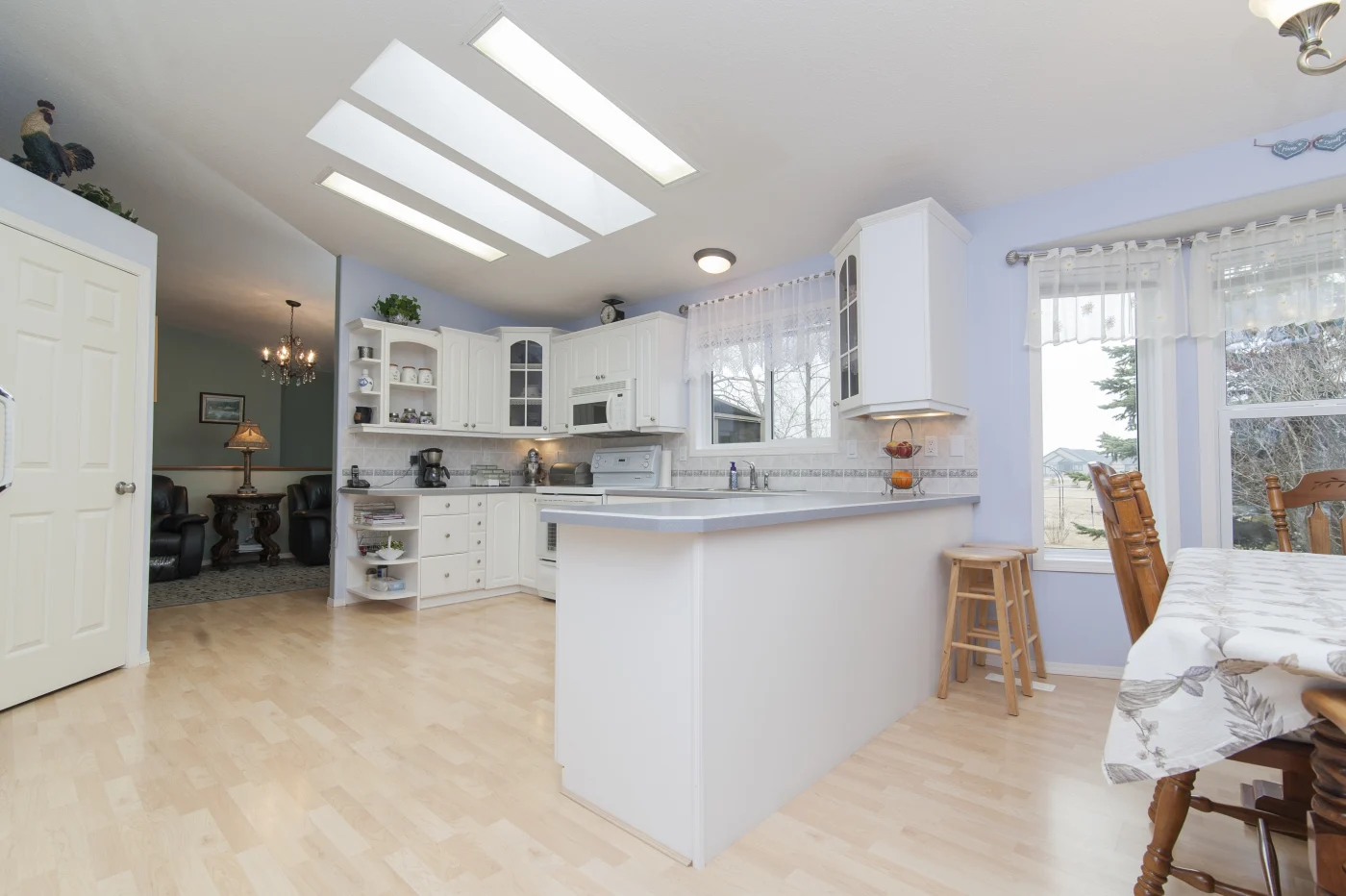 Beautiful kitchen completed with white cabinets and light colored countertops.