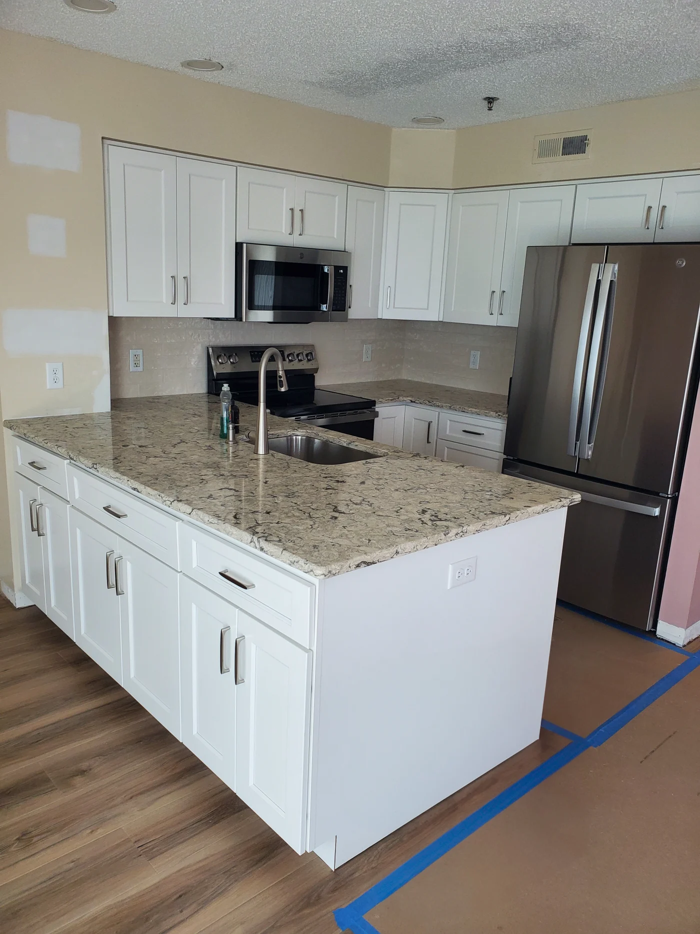 Amazing Kitchen Remodel | Salisbury, MD | Mast Contracting Newly remodeled kitchen with white shaker cabinets, stainless steel appliances, and granite countertops.