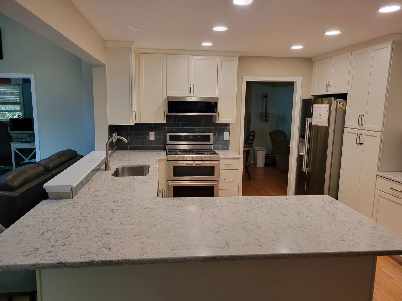Exquisite Kitchen Remodel | Salisbury, MD | Mast Contracting Modern kitchen remodel featuring white cabinetry, stainless steel appliances, and gray subway tile backsplash.