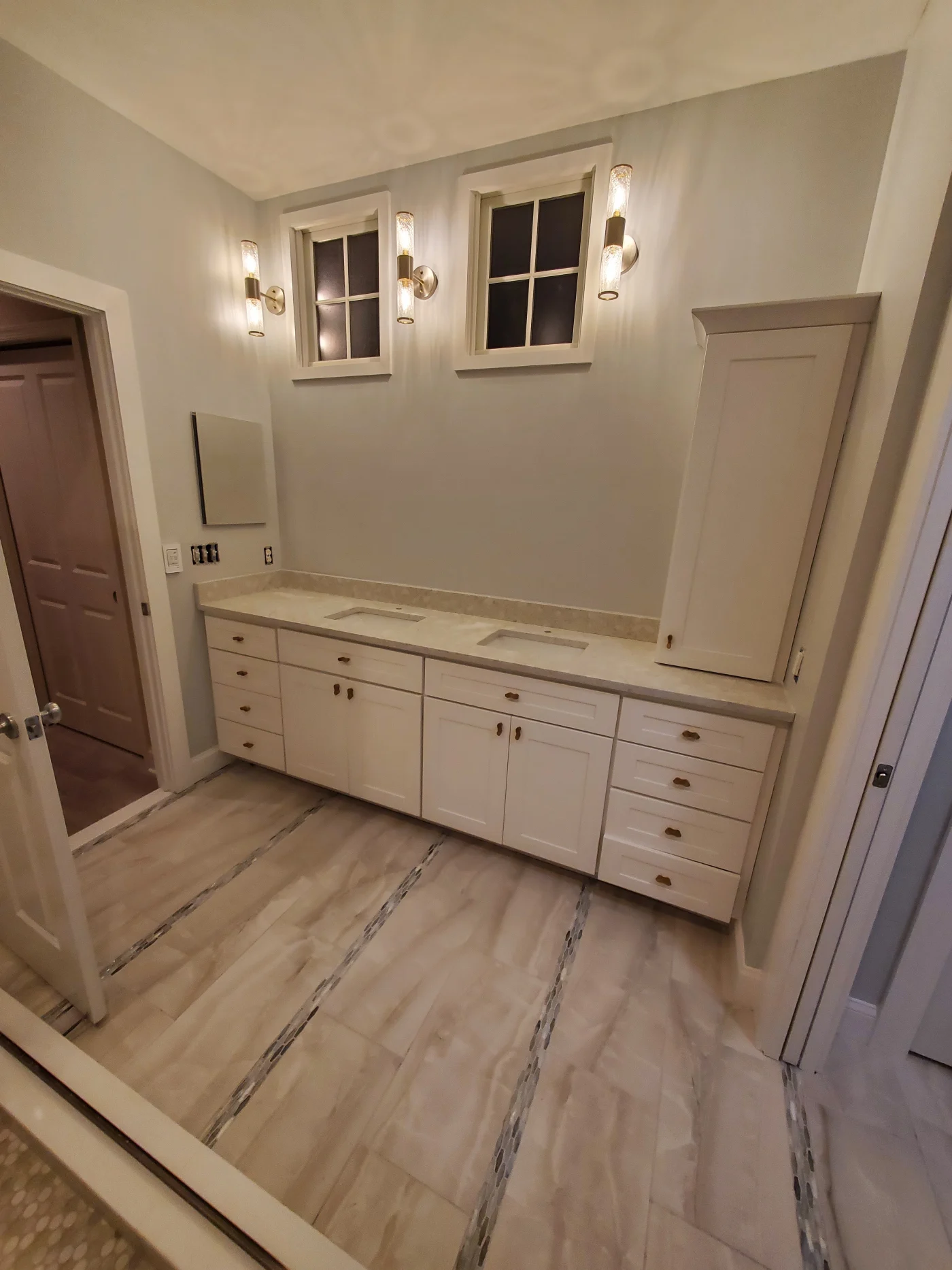 Impressive Full Bathroom Remodel | Salisbury, MD | Mast Contracting Elegant bathroom with double sinks and a long vanity featuring white cabinetry and stone countertops.