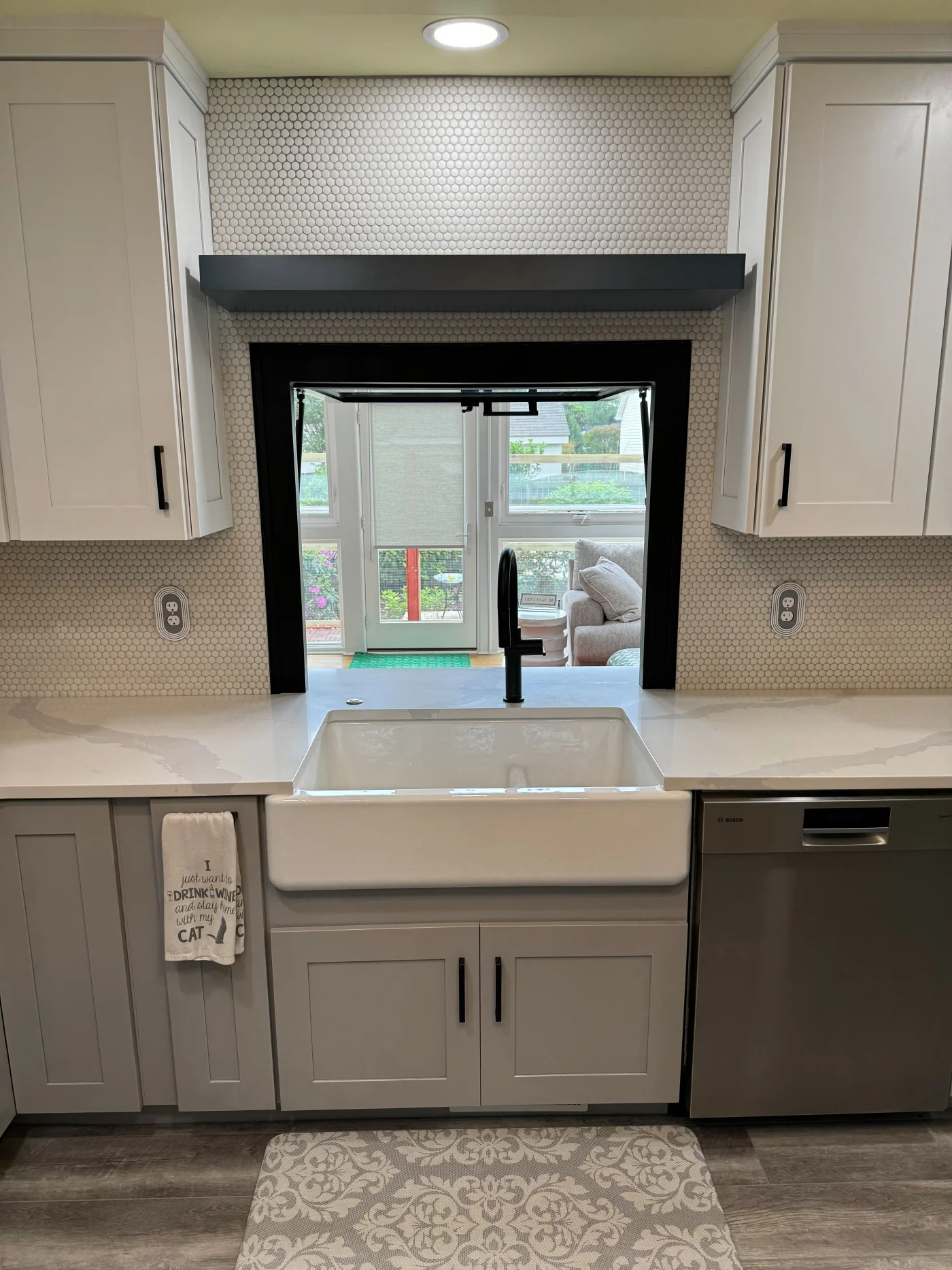 Exquisite Kitchen Remodeling | Frankford, DE | Mast Contracting Modern kitchen remodeling featuring shaker-style cabinets, a farmhouse sink, quartz countertops, a hex-tile backsplash, and matte-black fixtures.