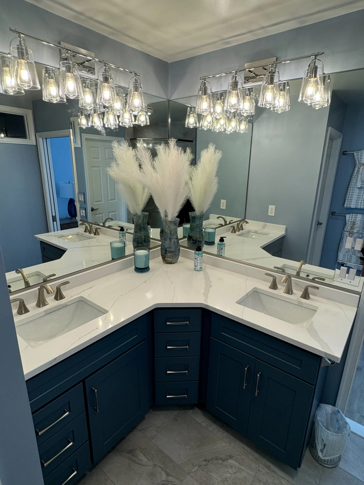 Glowing Bathroom Remodel | Frankford, DE | Mast Contracting Full bathroom remodel featuring a corner double vanity with quartz countertops, blue shaker cabinets, brushed nickel fixtures, and oversized mirrors.